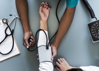 Nurse measuring patient blood pressure